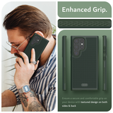 Image featuring a man on the left side talking on the phone. The phone is protected by a dark green phone case for Samsung Galaxy S24 Ultra. On the right, a close-up reveals the case's 'Enhanced Grip,' highlighting its textured surface. In the bottom right, the text emphasizes the secure and comfortable grip provided by the textured design on both sides and back of the case.